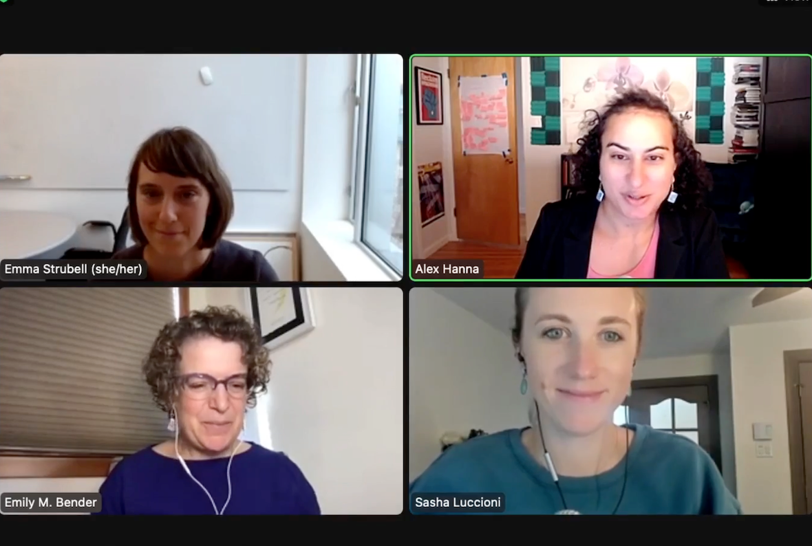 Screenshot of a Zoom meeting with four participants. On the bottom left panel is Emily M. Bender, a white woman with curly brown hair. She is wearing glasses, white wired headphones, and a purple top. Behind her are closed beige window blinds and a white wall. On the top left is Emma Strubell, a white woman with straight brown hair to her chin. She is sitting in a room with a whiteboard behind her and a window to her right. On the top right is Alex Hanna, an Arab woman with shoulder-length curly black hair. She wears earrings, a pink shirt, and a black blazer, and the room behind her has art all over the walls. On the bottom right is Sasha Luccioni, a white woman with her blond hair pulled back behind her. She wears black wired headphones and a teal top. Behind her is a room with white walls and wood-framed windows.