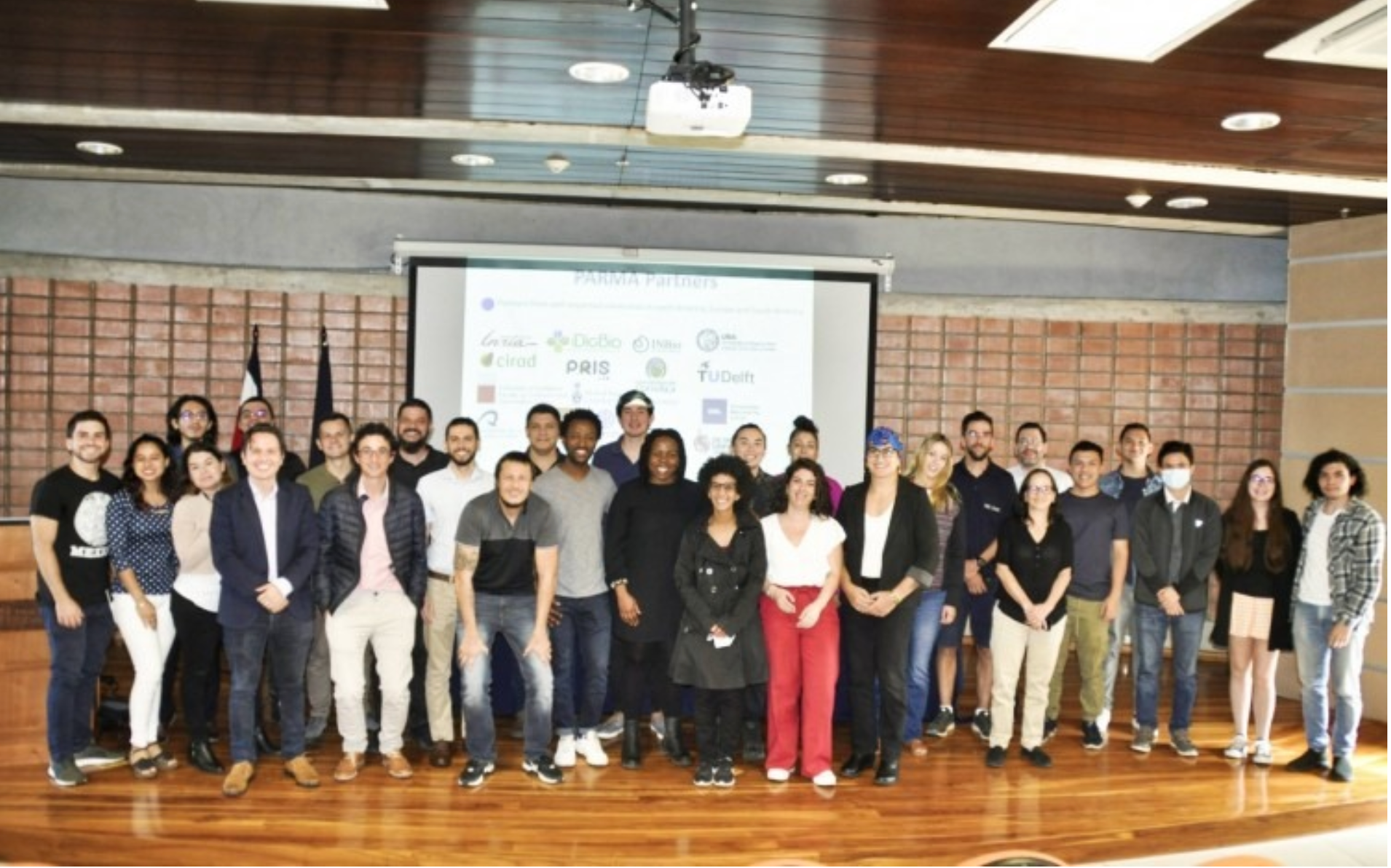 A photo of the DAIR team and the researchers and students we met from Tecnológico de Costa Rica on a stage.