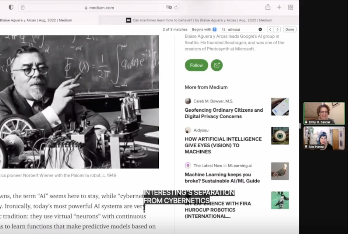 Screencap of a Zoom meeting. On the left, very large, is a screenshared website, with a black and white photo of a white man wearing spectacles. Behind him is a chalkboard covered in equations, and on the desk in front of him are various technical-looking machine parts. Words in the article are cut off, but include phrases like "today's most powerful AI systems" and "they use virtual 'neurons'". On the right are two tiny thumbnails of the meeting participants: Emily Bender, a white woman with curlybrown hair, and Alex Hanna, an Arab woman wearing a blue head wrap.