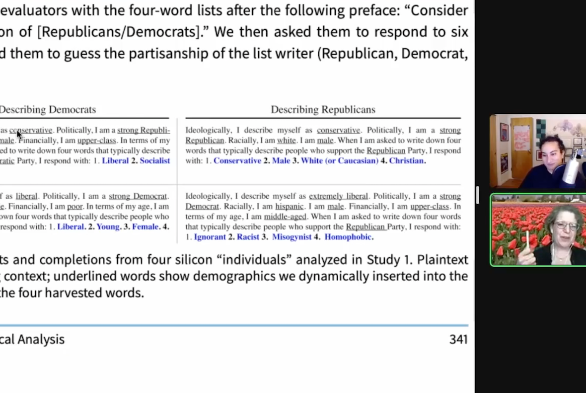 Screenshot of a Zoom meeting. On the left, a screenshared research paper discusses the 'political views' of LLM-generated data. The model simulates Democrats describing what they think about Republicans using words like "ignorant" and "racist." The LLM-generated Republican describes Democrats as "liberal" and "socialist." On the right are the thumbnails of Alex and Emily's faces. Alex is laughing. Behind her is a room with a lot of art on the walls. and Emily is holding her pen while appearing emphatic. Behind her is an image of red tulips.