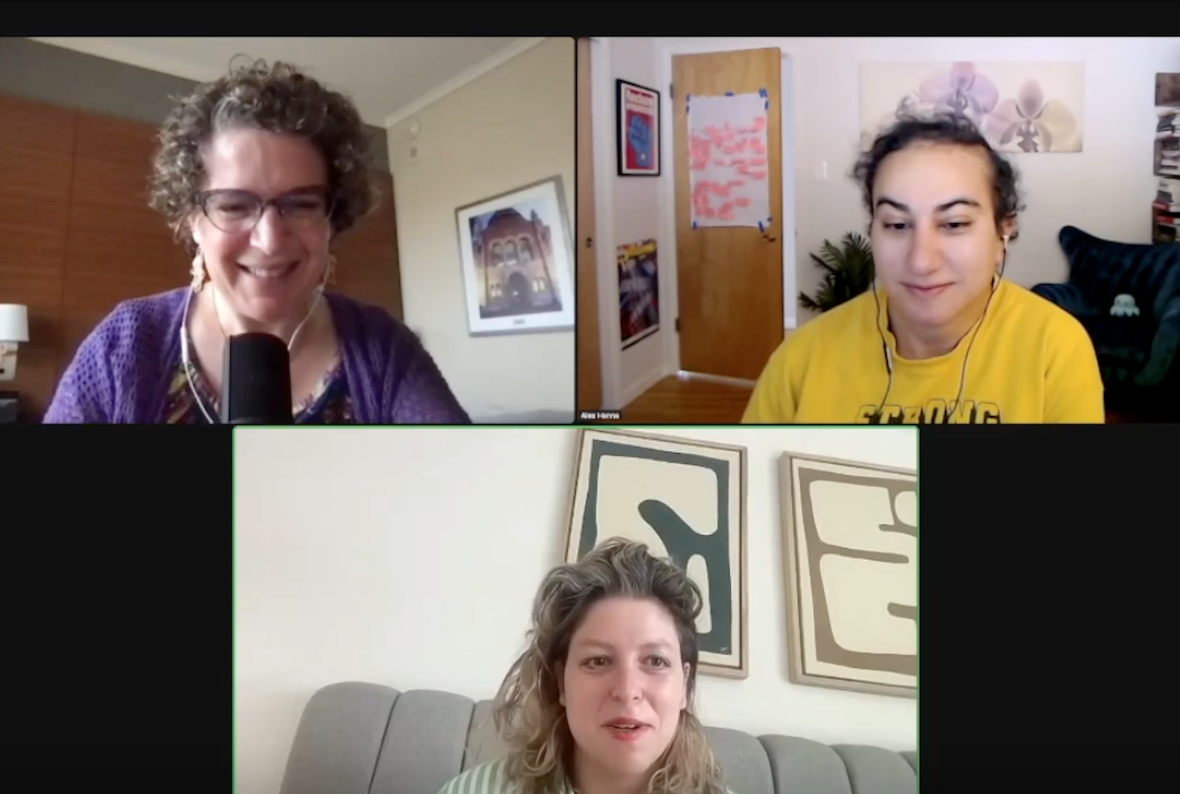 Screenshot of a Zoom meeting with three participants. On top left is Emily Bender, a white woman with short-ish curly brown hair. She wears glasses, earrings, and a purple top. Behind her is a room with one brown wall and one off-white wall, and a painting on her right. On the top right panel is Alex Hanna, an Arab woman with her black, curly hair pulled back. She is wearing a yellow top. Behind her is a room with multiple pieces of art on the walls and a plant on the floor. On the bottom panel is Hannah Zeavin, a white woman with curly blond hair with dark roots. She is wearing a top with green and white stripes, and sits in front of an art-covered white wall.