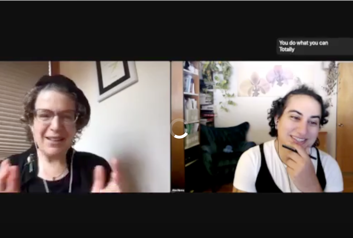 Screenshot of a Zoom meeting. On the left is Emily Bender, a white woman with short-ish curly brown hair. She wears glasses, earrings, and a black shirt, as well as a black beret. Behind her is a white wall and some closed beige window blinds. On the right panel is Alex Hanna, an Arab woman with medium-length black hair. She is wearing a black jumper over a white t-shirt. Behind her is a room with bookshelves on one side and several plants.