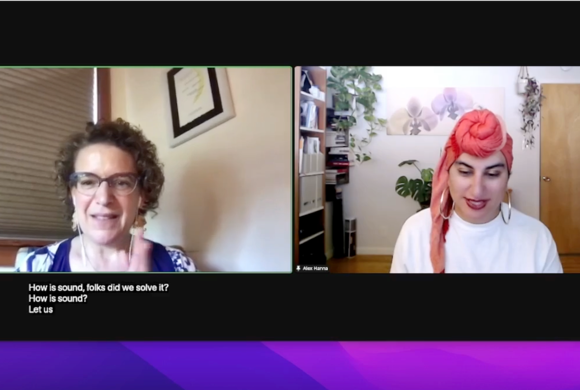Screenshot of a Zoom meeting. On the left is Emily Bender, a white woman with short-ish curly brown hair. She wears a purple and white top, and behind her is a white wall and some closed beige window blinds. On the right panel is Alex Hanna, an Arab woman with her hair in a peach-colored head wrap. She wears a white shirt and big hoop earrings. Behind her is a room with bookshelves on one side and several plants.